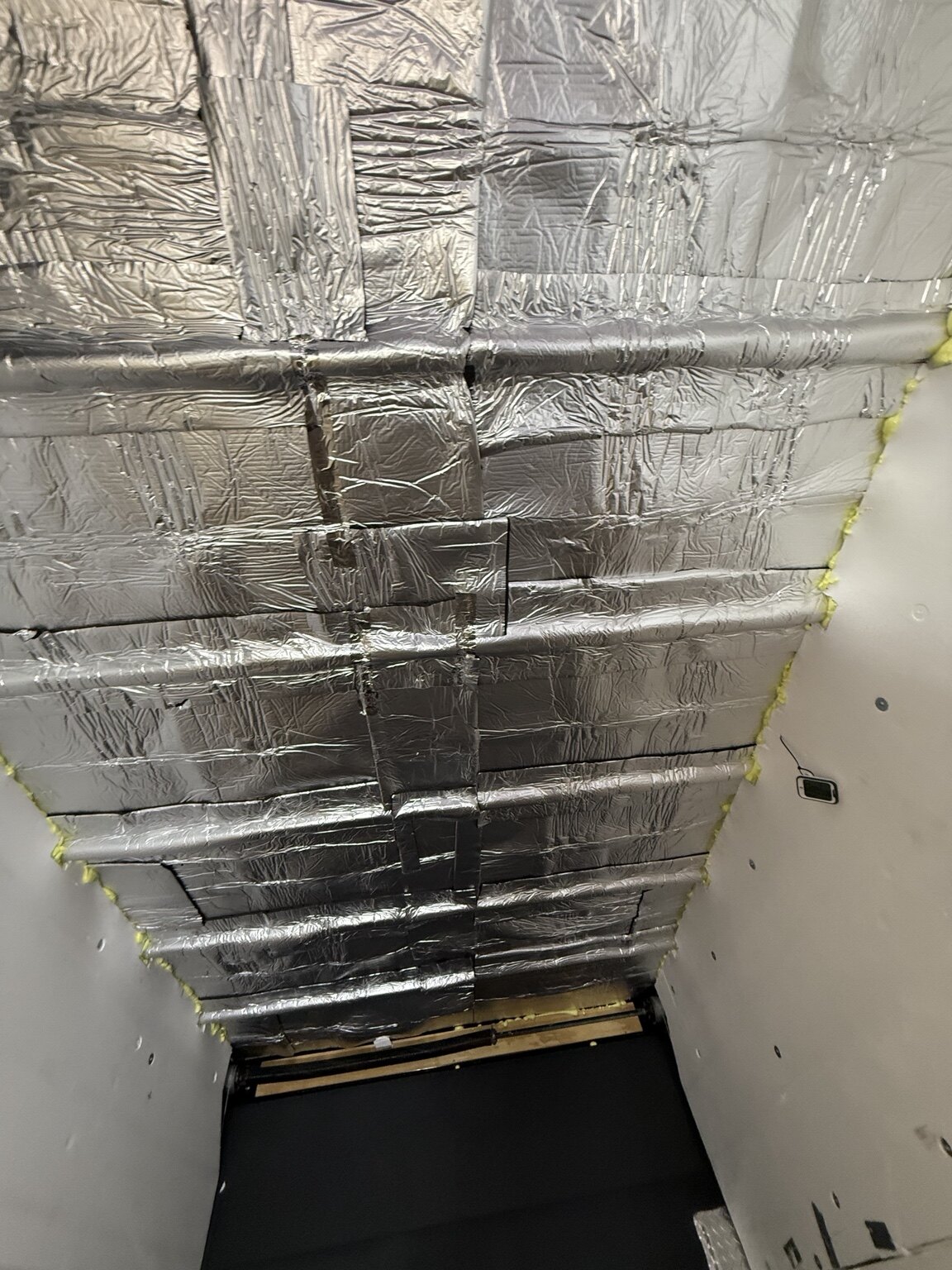Black Trailer Solar & Off-Grid Conversion Reflective insulation installed across the trailer ceiling and walls